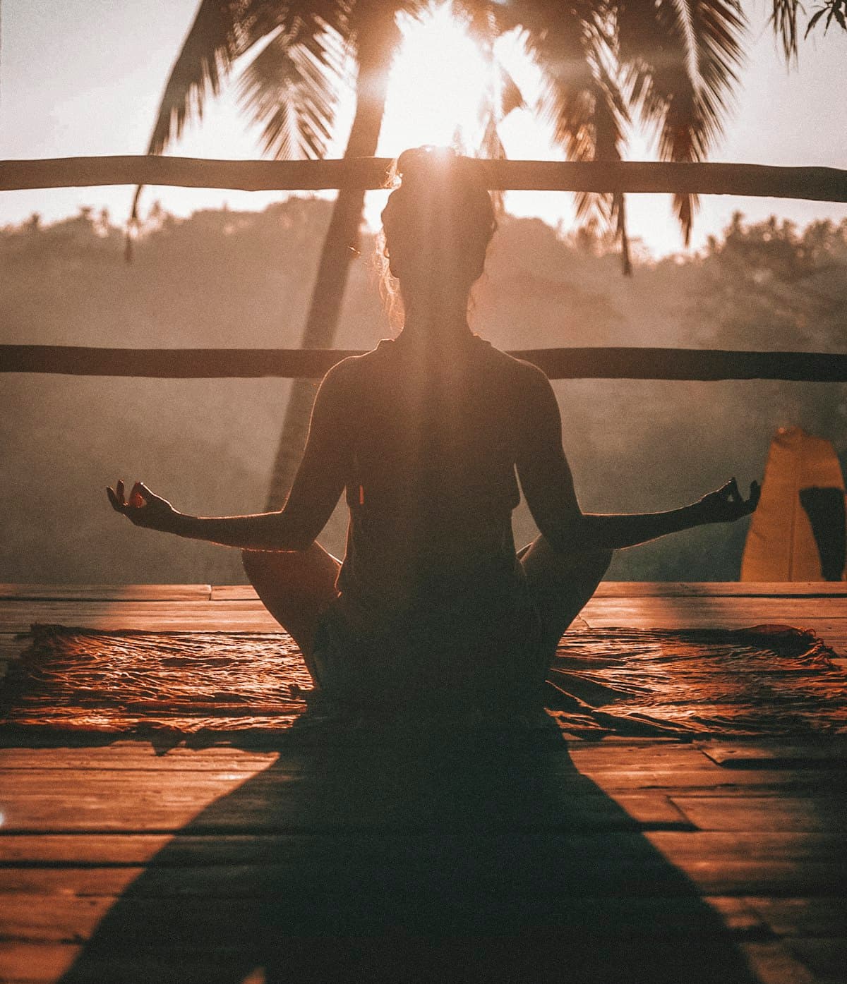 Person meditating peacefully with eyes closed outdoors